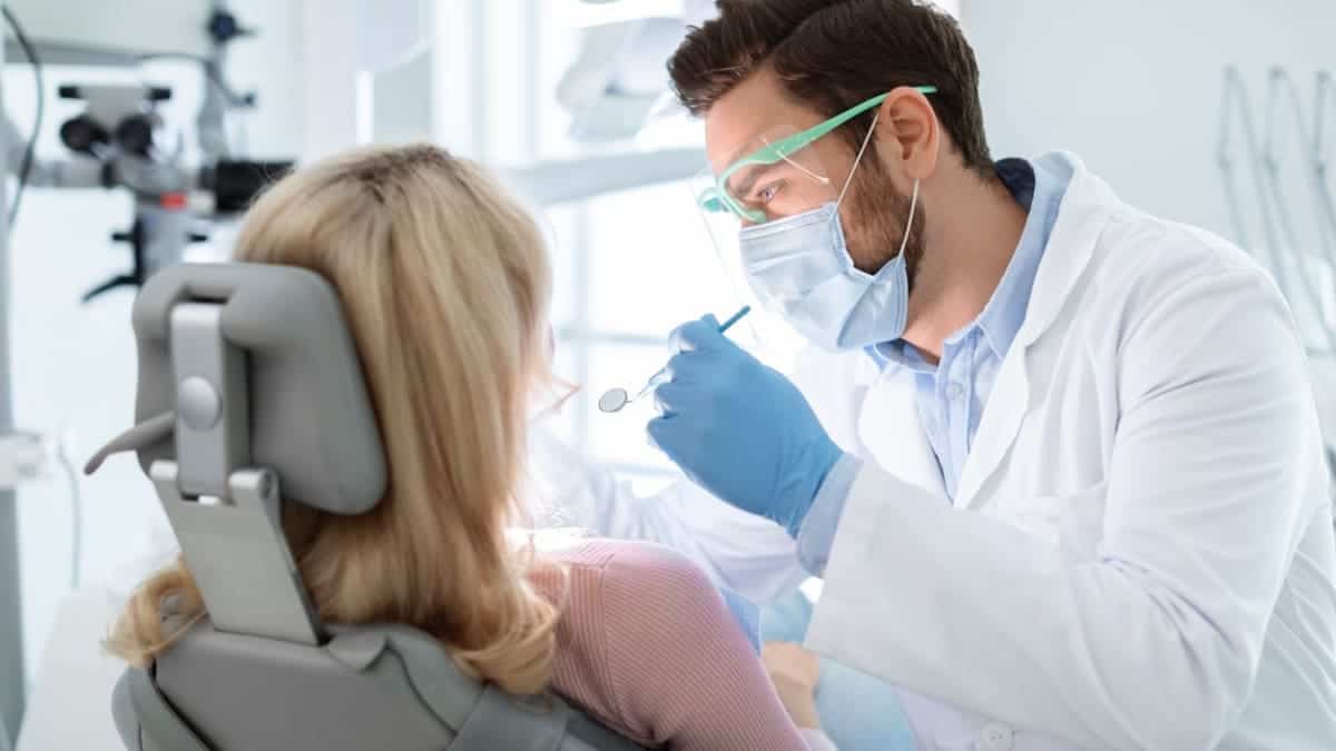 Patient receiving professional teeth whitening with a laser device Bolton